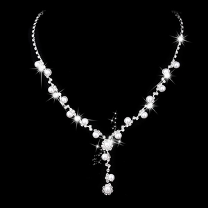 Elegant bridal necklace set with sunflower rhinestones and pearls on a black background