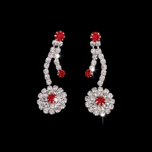 Silver bridal jewelry set featuring red crystal floral drop earrings on black background