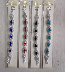 Detailed view of silver claw chain bracelets with multi-color marquise crystals