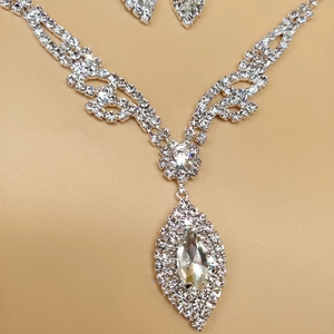 Macro view of silver bridal jewelry set with sparkling marquise-cut rhinestones