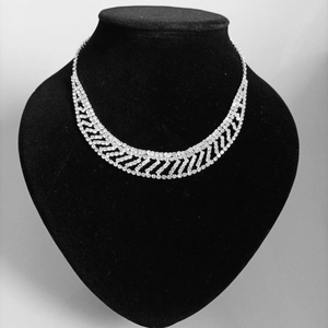 Detailed macro view of sparkling rhinestone bridal necklace on velvet display stand