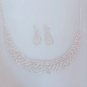 Macro detail of silver rhinestone bridal necklace and drop earring jewelry set