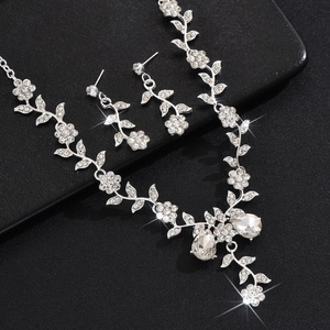 Macro shot of silver sunflower jewelry set with sparkling rhinestones and crystal teardrops