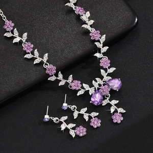 Detailed view of luxury purple crystal floral jewelry set with teardrop pendant stones