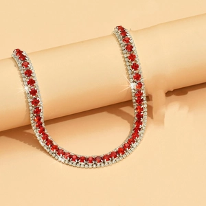 Macro shot of three-row luxury necklace with bright red stones and clear crystals