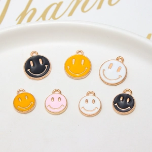 Detailed macro shot of colorful enamel smiley face charms in a white porcelain dish
