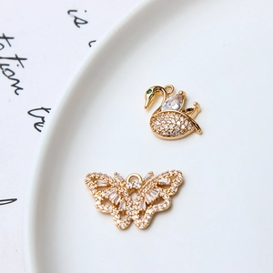 Gold-plated swan and butterfly charms with sparkling white zircons for DIY jewelry