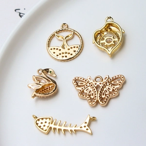 Gold-plated dolphin, butterfly, and fishbone charms set with zircon for DIY jewelry making