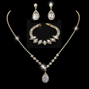 Elegant gold teardrop jewelry set with crystal necklace earrings and tiered bracelet