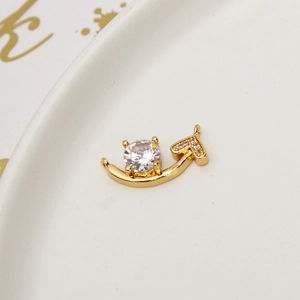 Close-up of gold-plated link charm with cubic zirconia main stone and heart detail