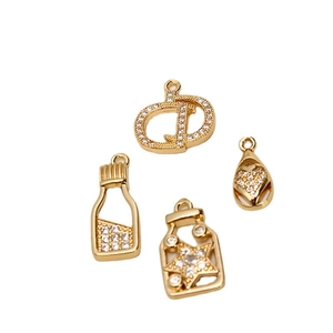 Golden DIY jewelry pendants set with zircon crystals featuring crown and heart designs
