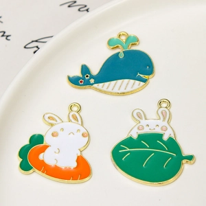Detailed macro view of colorful enamel alloy charms featuring whale and rabbit designs