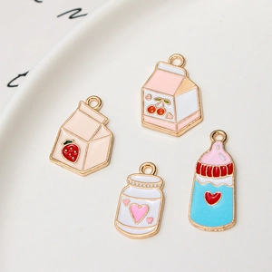 Détails macro de quatre breloques en émail type brique de lait fraise et cerise