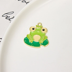 Detailed macro view of a cartoon frog on lotus leaf enamel charm with gold plating
