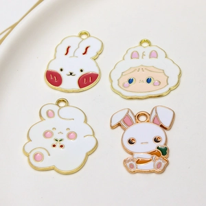 Close-up of four cute cartoon bunny alloy charms with enamel finish for DIY jewelry