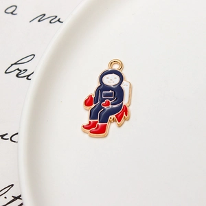 Detailed view of enamel astronaut pendant with blue space suit and golden plated finish