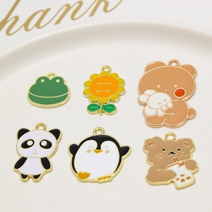 Macro detail of six cute enamel animal charms including bear and penguin for DIY jewelry