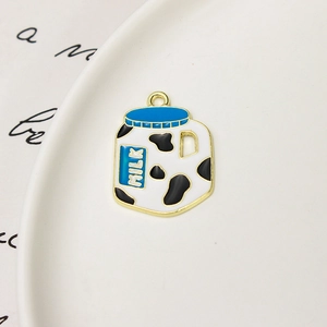 Vue macro d'un pendentif en alliage de brique de lait avec motifs de vache pour bijoux DIY
