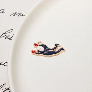 Detailed macro view of a cartoon astronaut enamel charm with gold-plated metal finish