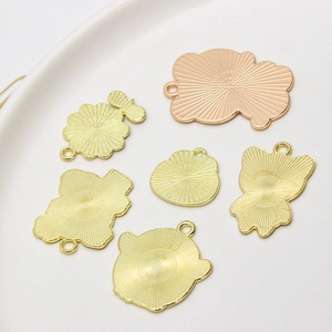 Detail of cute gold alloy animal charms with radiating texture and top ring loop