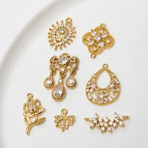 Macro detail of gold-plated copper flower pendants with zircons for DIY jewelry making