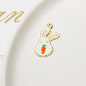 Detailed macro view of a cartoon rabbit alloy pendant with enamel carrot and gold trim
