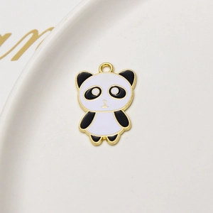 Detailed macro of a gold enamel panda pendant accessory for DIY jewelry making