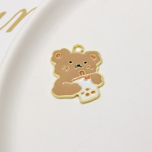 Macro shot of cartoon bear with bubble tea alloy charm for DIY jewelry making