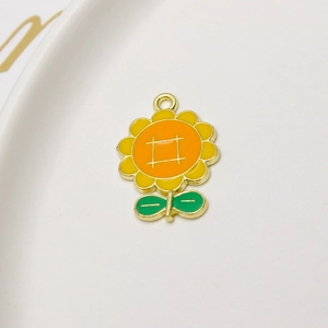 Macro detail of alloy sunflower pendant charm with yellow enamel petals and top jump ring