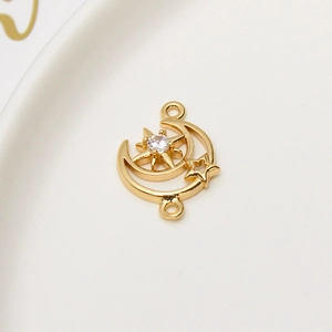 Macro shot of gold moon and star pendant connector with cubic zirconia for jewelry making