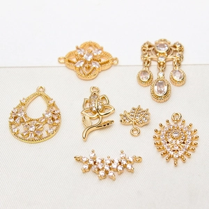 Macro shot of gold plated DIY jewelry charms with zircon inlay for handmade accessories