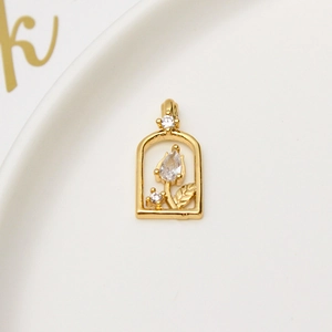 Macro view of gold-plated tulip pendant with clear zircon stone in arch frame