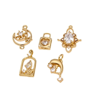 DIY jewelry pendants set with gold-plated charms and zircon inlay on white background