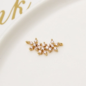 Macro detail of gold-plated flower pendant with pavé cubic zirconia for DIY jewelry making