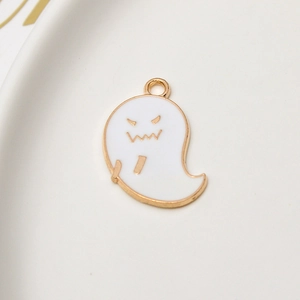 Macro view of white enamel ghost charm for DIY jewelry with gold metal edges