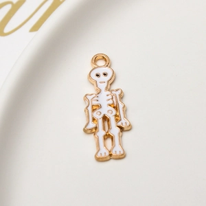 Close-up of white enamel skull pendant with gold plating for Halloween DIY jewelry