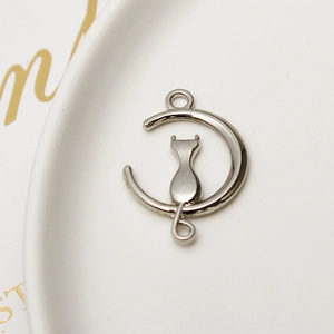 Macro view of silver moon and cat metal pendant connector for DIY jewelry making