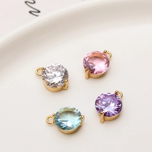 Macro view of 8mm circular colorful zircon pendants with gold plated prong settings
