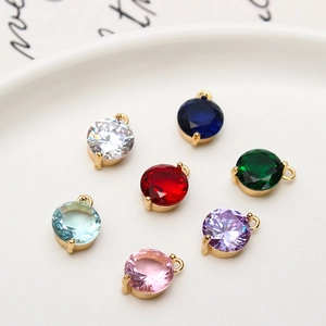 Macro shot of 8mm round colorful cubic zirconia charms with gold plated claw settings