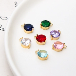 Close-up of 8mm round multifaceted zircon pendants in seven colors for jewelry making