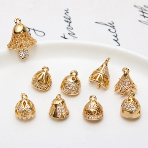 Macro detail of gold plated copper bell charms with CZ zircon for DIY jewelry making