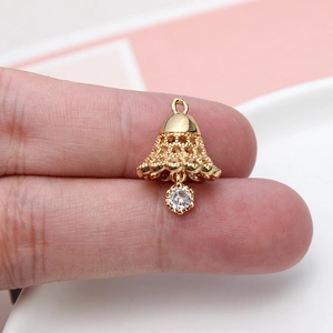 Detail of copper zircon hollow bell charm for DIY earring and bracelet making