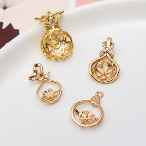 Detailed macro of gold plated hollow cherry and pouch shaped DIY pearl pendant settings
