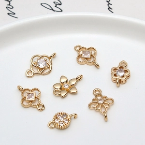 Macro detail of gold plated cubic zirconia hollow floral connector charms for DIY jewelry