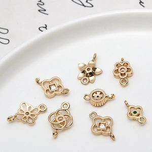 Detailed view of gold-plated hollow geometric flower connectors with cubic zirconia stones
