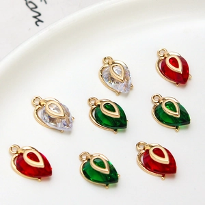 Macro shot of gold-plated heart-shaped zircon pendants in red, green, and clear white