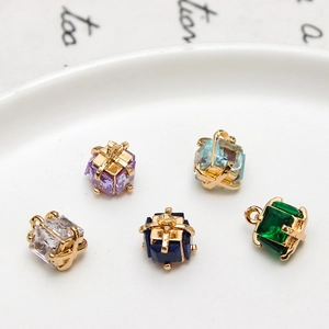 Detailed view of colorful cubic zirconia gift box pendants with gold-plated metal wire