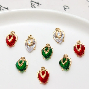 Macro shot of gold-plated teardrop pendants with colorful faceted zircon stones in a dish