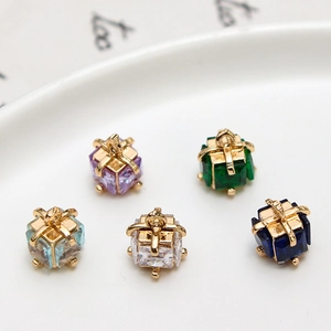 Detailed macro shot of five cubic colorful crystal pendants with golden gift wrap metal frame