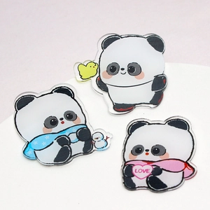 Three cute cartoon panda acrylic pins with heart, scarf, and yellow duckling designs